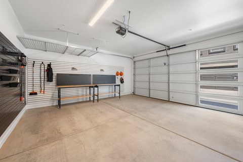 A spacious garage with a concrete floor and white walls.