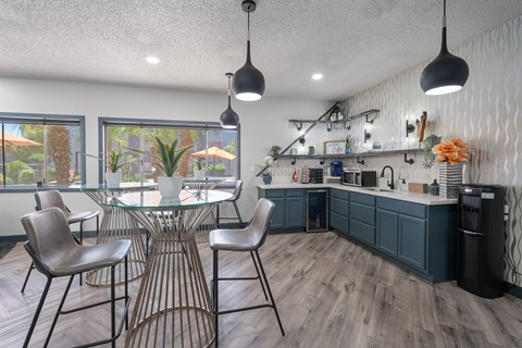 A modern dining room with a glass table and chairs.