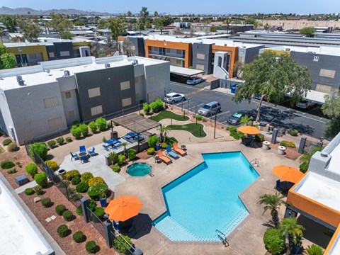 Aerial view of pool with lounge chairs at Newport apartments in Avondale, AZ.