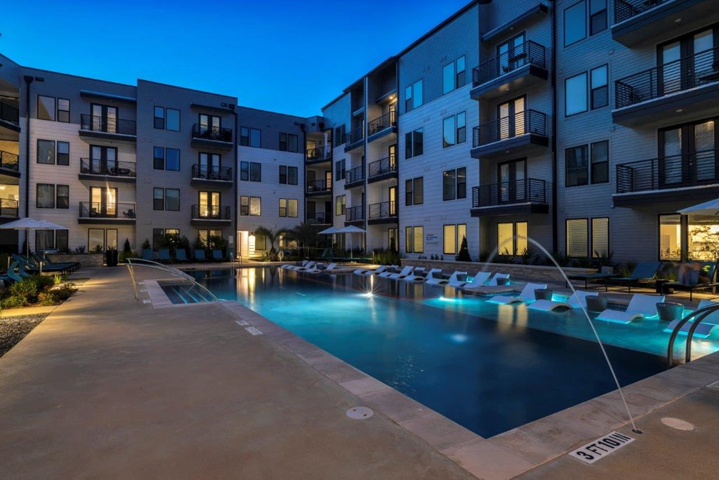 Nexus East Outdoor Pool with Lights and Lounge Chairs