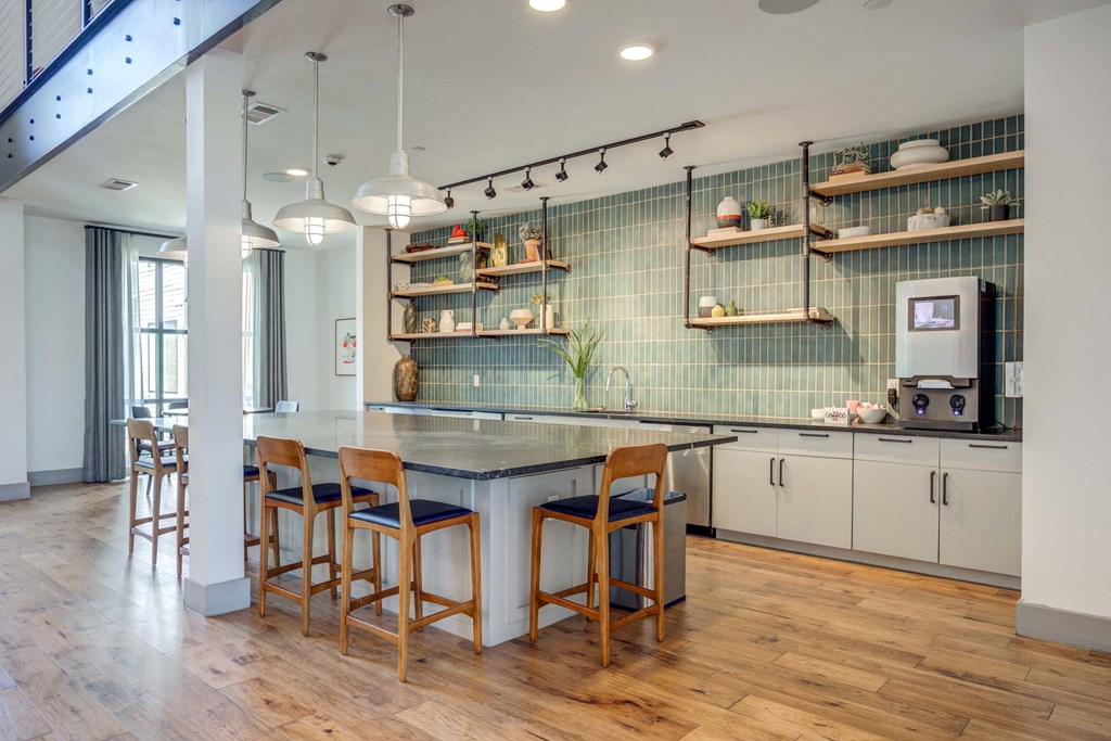 a kitchen with a blue counter top and chairs