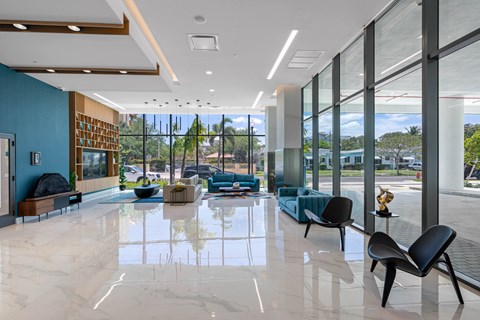 A spacious waiting area with a marble floor and blue walls