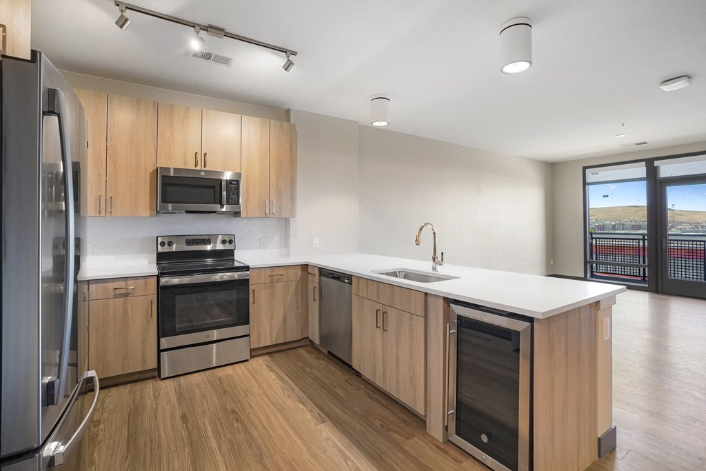 Kitchen with built-in beverage cooler or wine fridge  at Novus, Lone Tree, Colorado