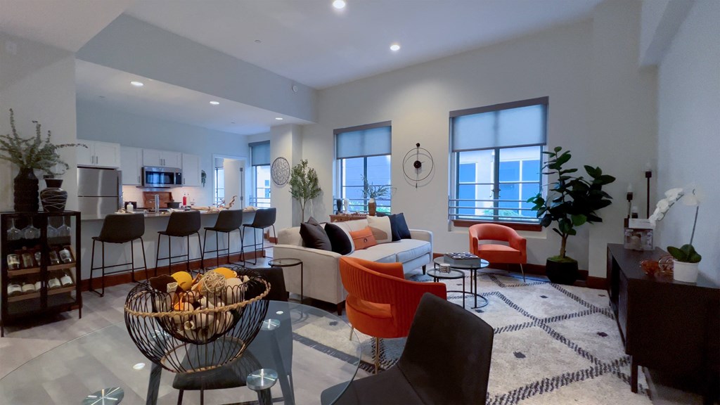 a living room with a couch and a table and a kitchen