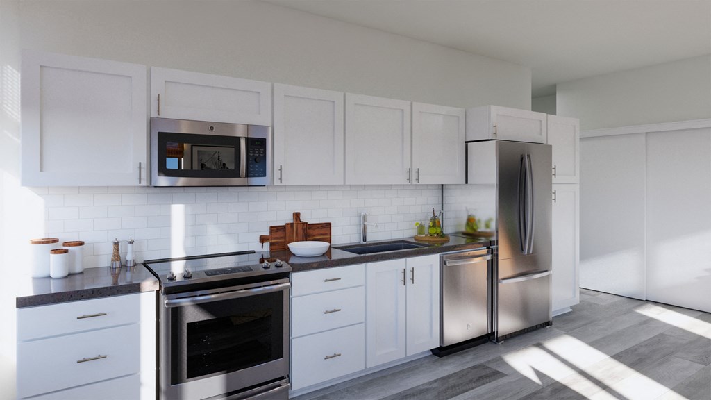 a white kitchen with stainless steel appliances and white cabinets