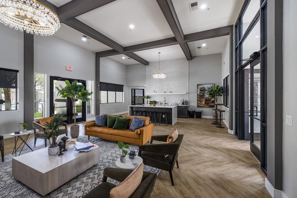 a living room with couches and chairs and a kitchen