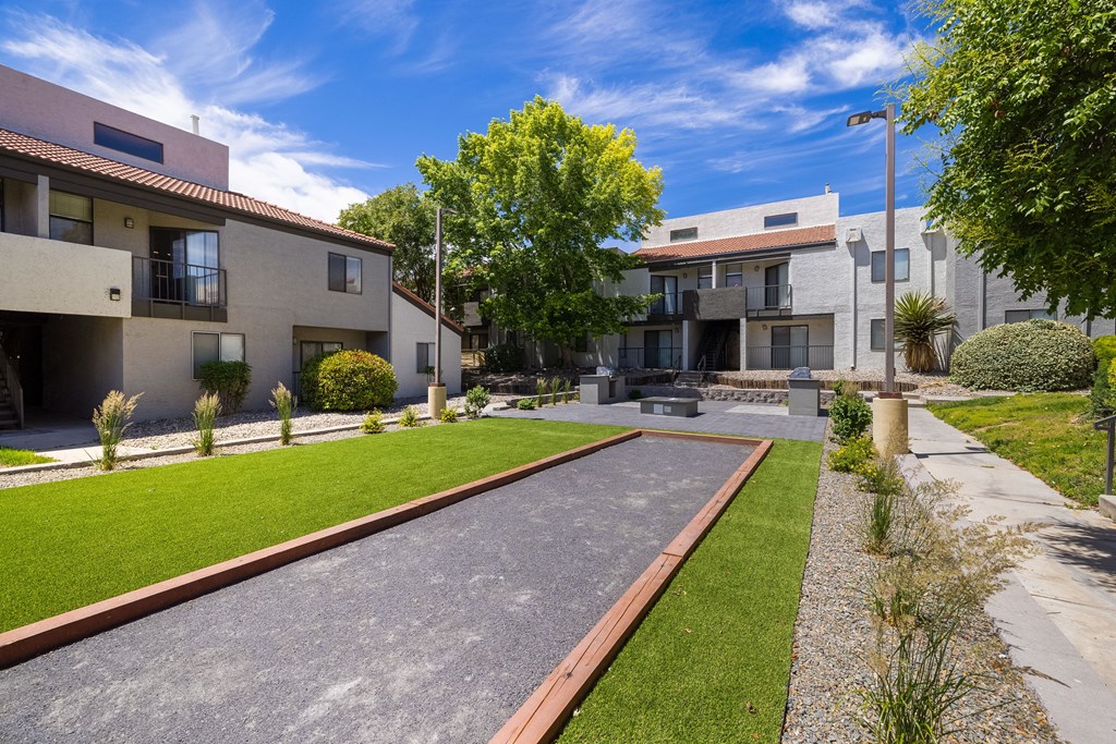 the yard of a house with a sidewalk and grass
