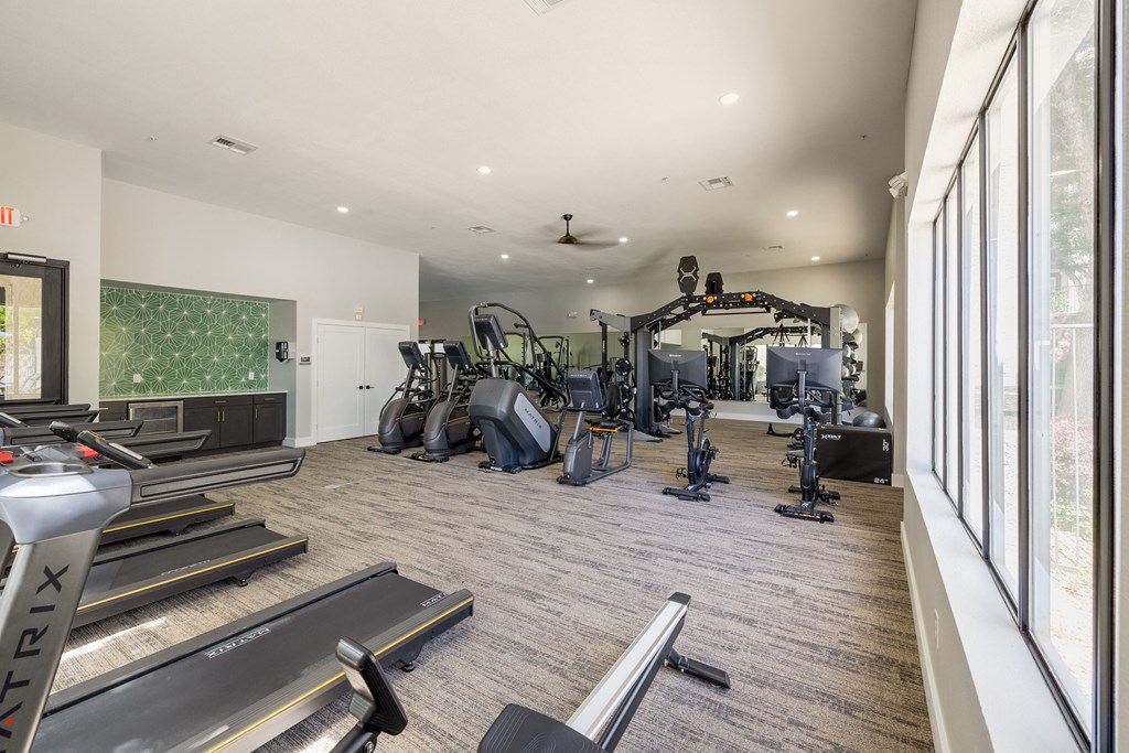 the gym is equipped with treadmills and other fitness equipment