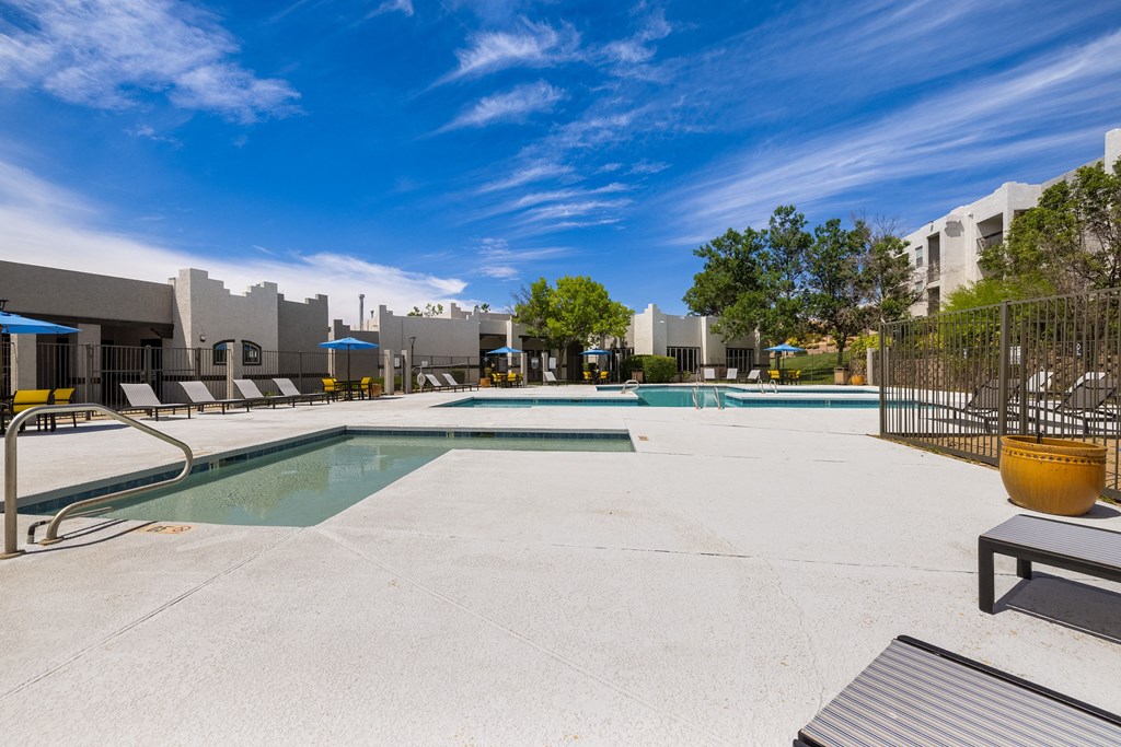 our apartments have a swimming pool with a city skyline in the background