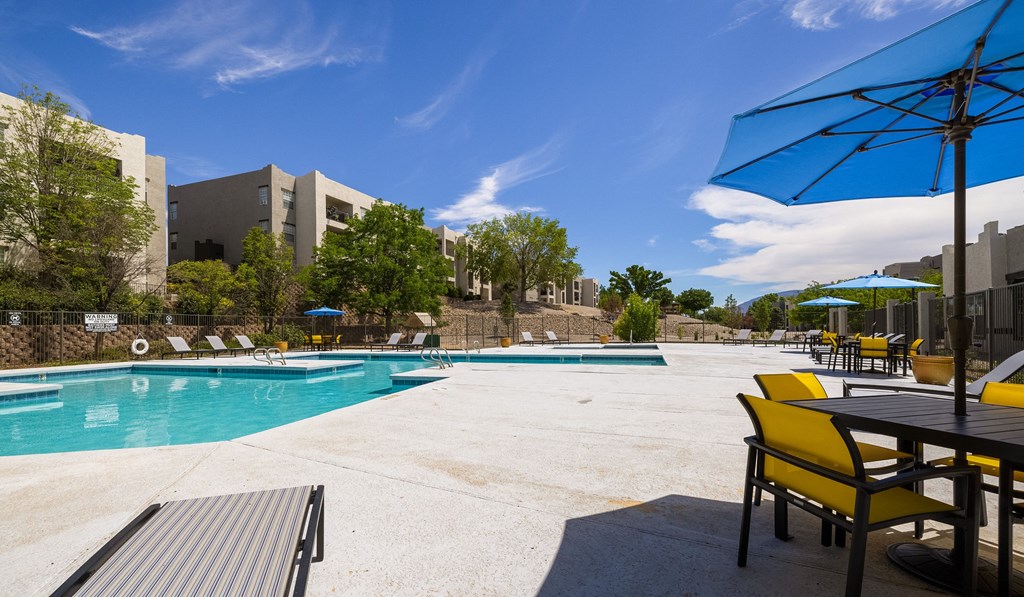 the preserve at ballantyne commons pool and patio with chairs and umbrellas