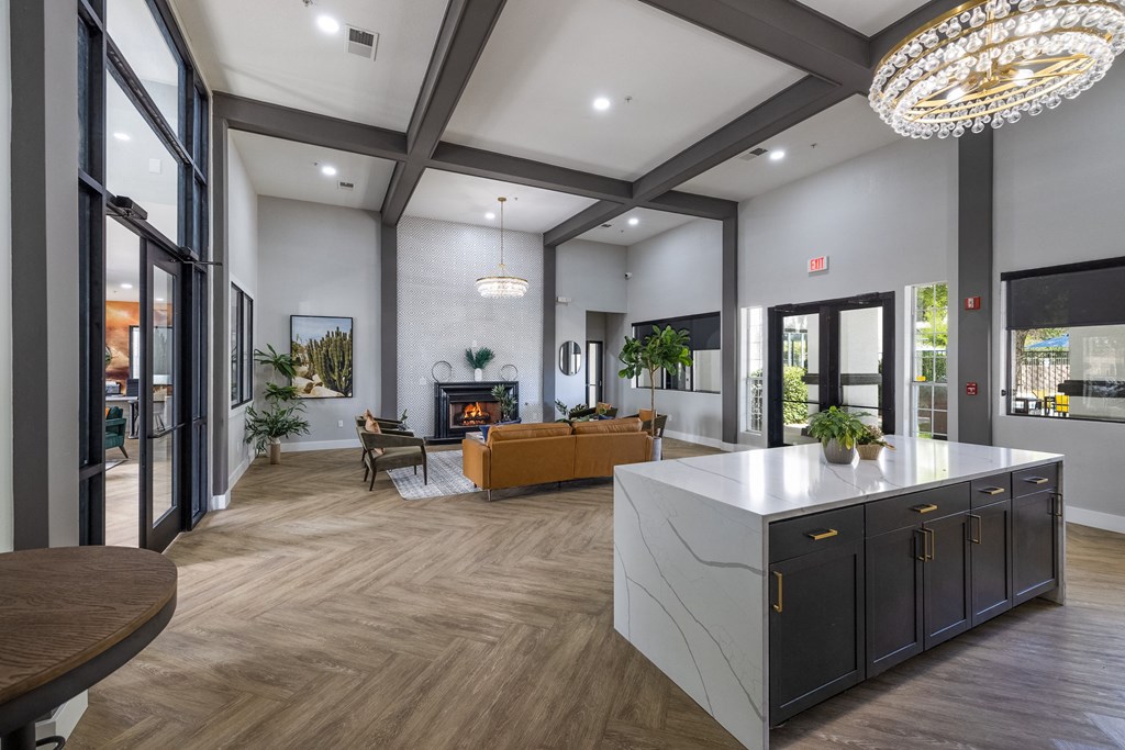a large living room with a kitchen and a fireplace