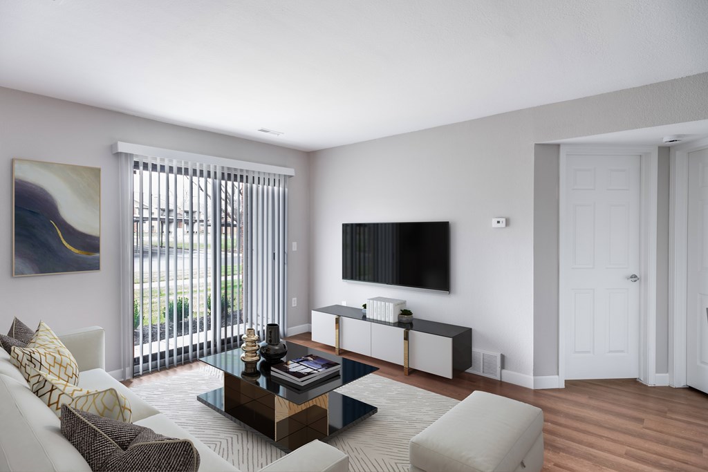 A living room with a white couch, a coffee table, and a painting on the wall.