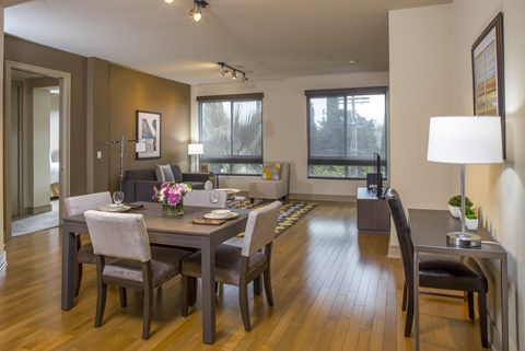 A dining room with a table set for four.