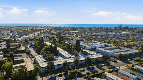 A cityscape with buildings and trees under a clear sky.
