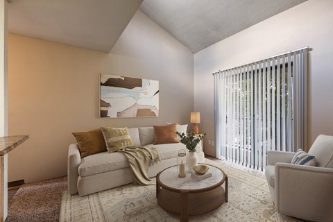 A living room with a couch, a coffee table, and a painting on the wall.