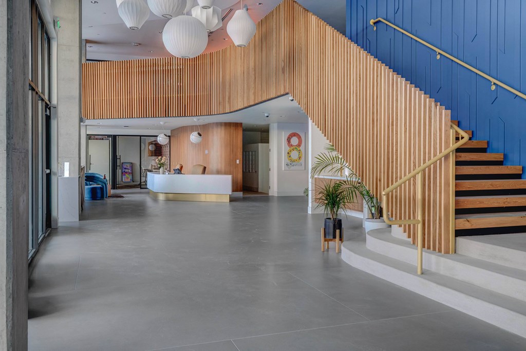A wooden staircase with a blue wall on the side.