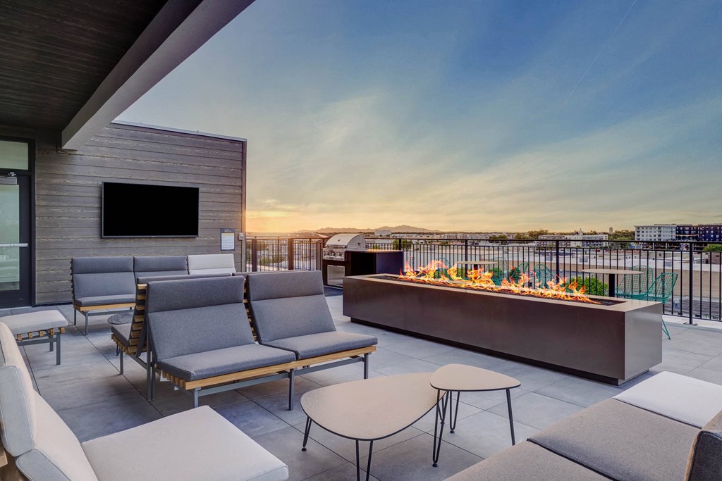 A patio with a fire pit and seating area.