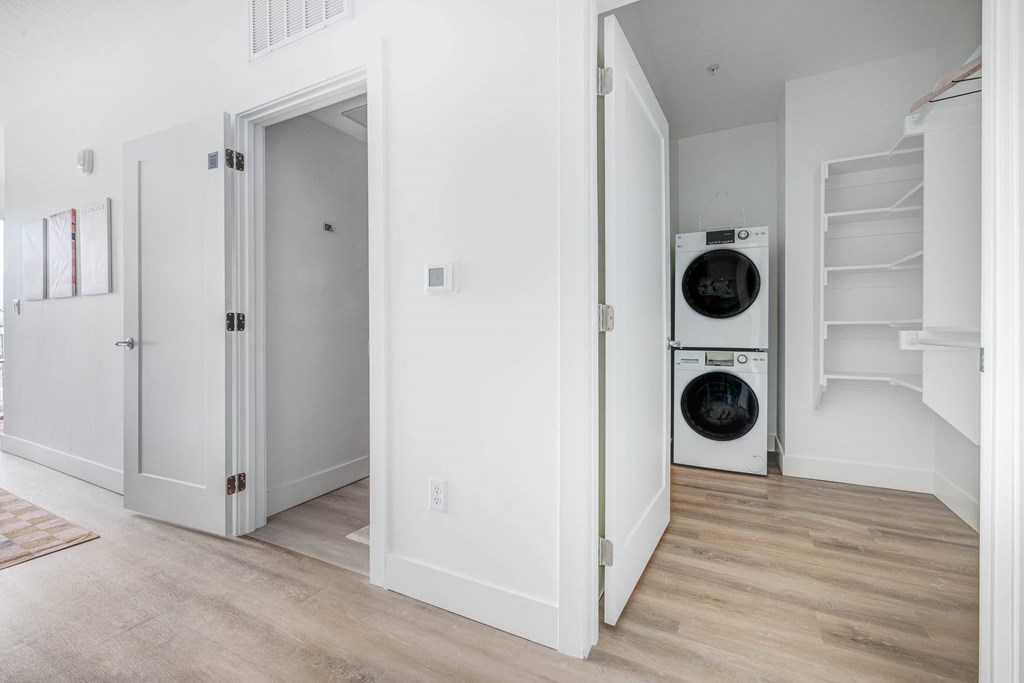 A white laundry room with a washer and dryer.