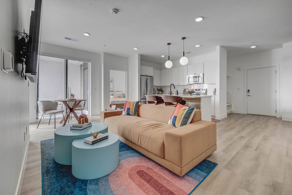 A living room with a couch, a coffee table, and a television.