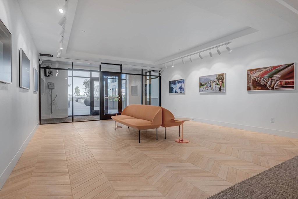 A room with a wooden floor and a brown chair.
