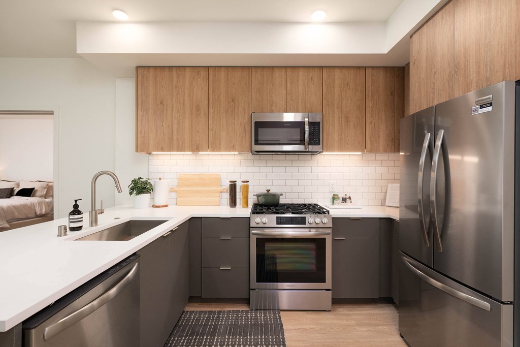 a kitchen with stainless steel appliances and a white counter top