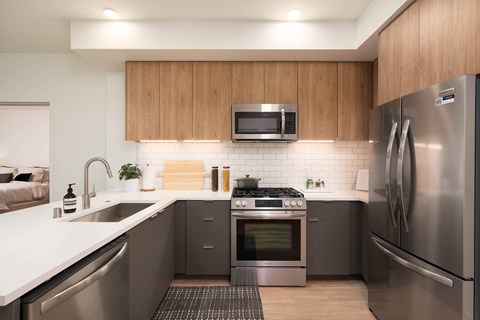 a kitchen with stainless steel appliances and a white counter top