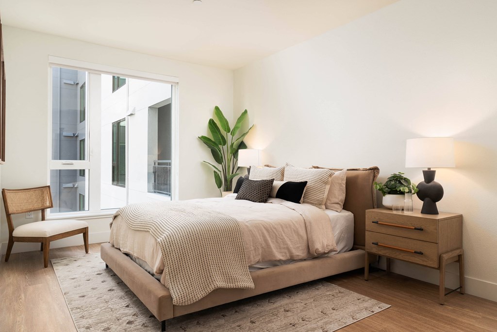 a bedroom with a bed and a window