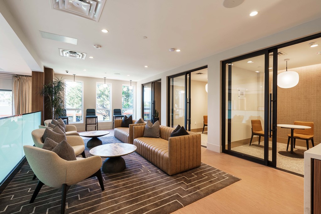 a living room with a couch and chairs and a table