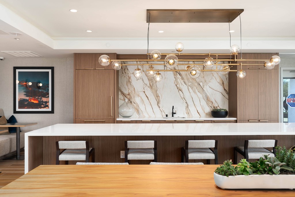 a kitchen with a large island and a table with chairs