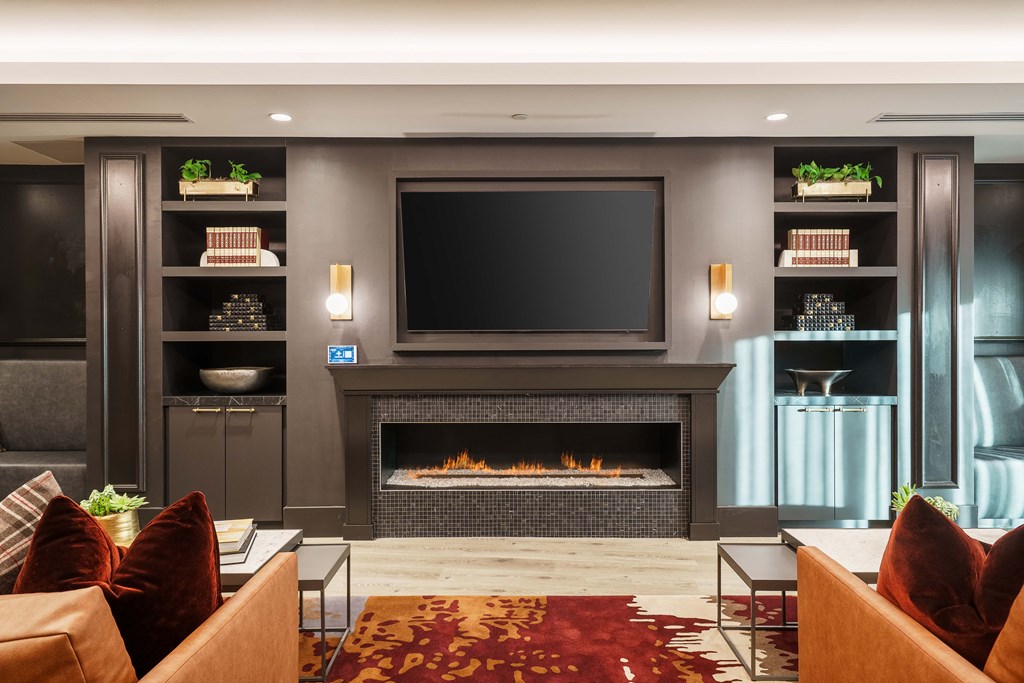 a living room with a fireplace and a television