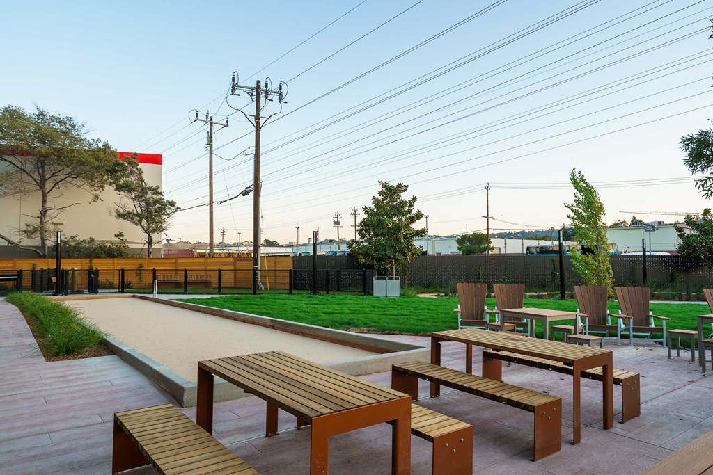 a seating area with benches and a lawn