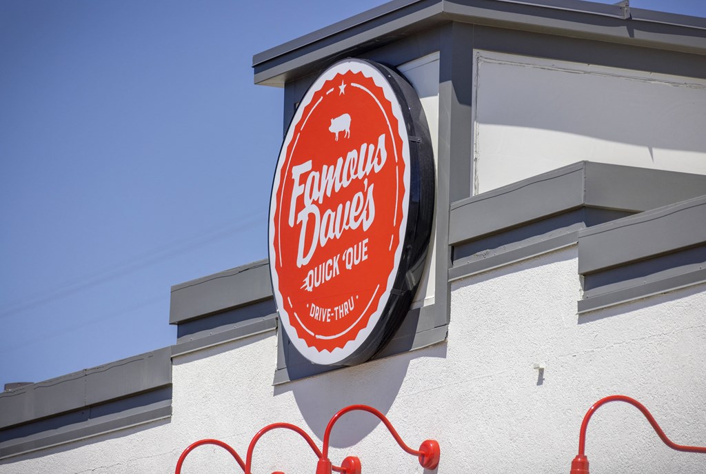 A sign for Fandango Drive-In sits on a building.