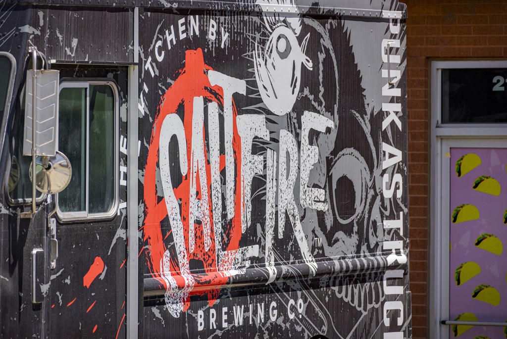 A truck with a large logo on the side that says