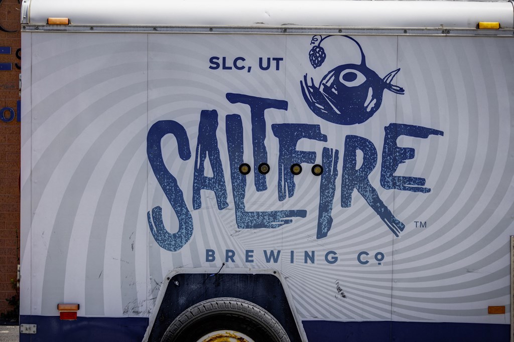 A truck with a blue fish and the words