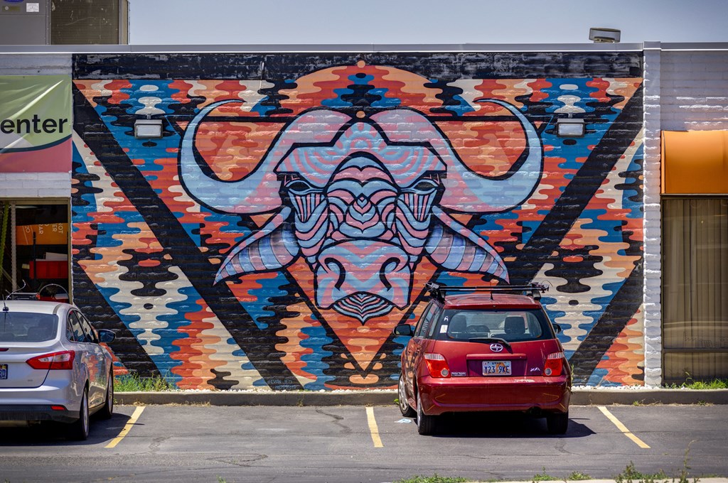 A mural of a bull's head is painted on a wall.
