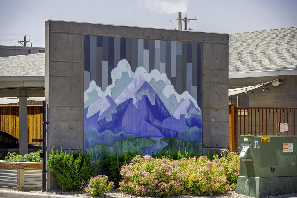 A mural of mountains painted on a wall.