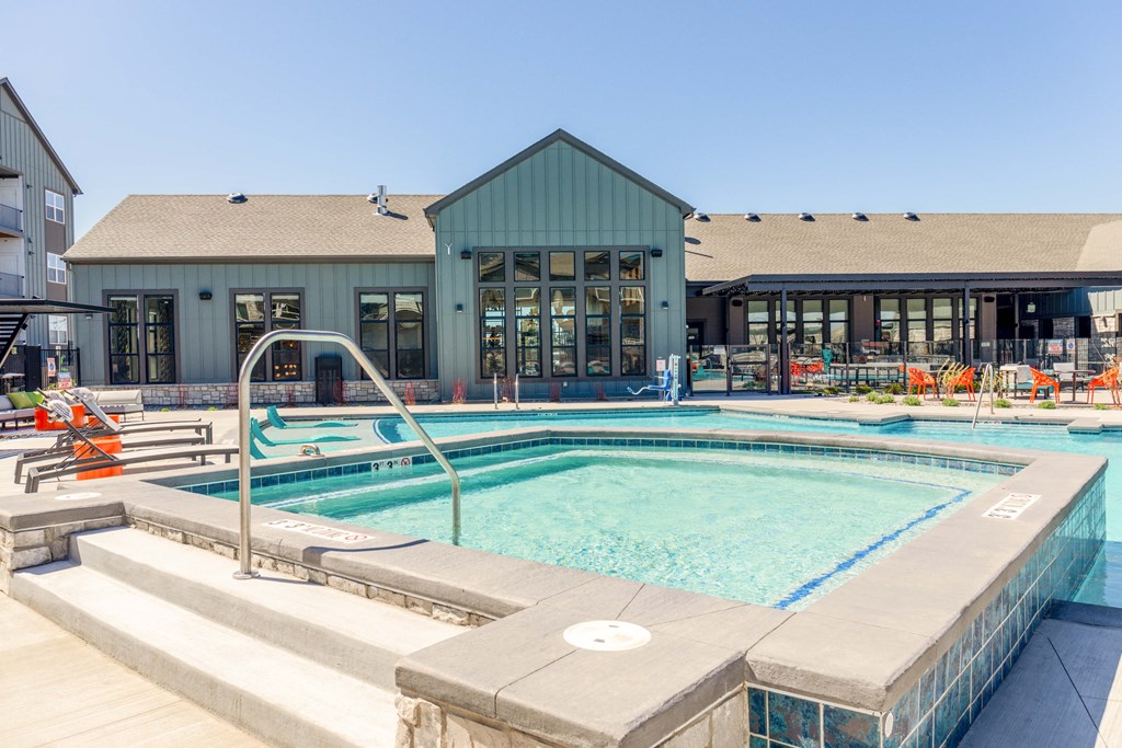a hot tub with a building in the background