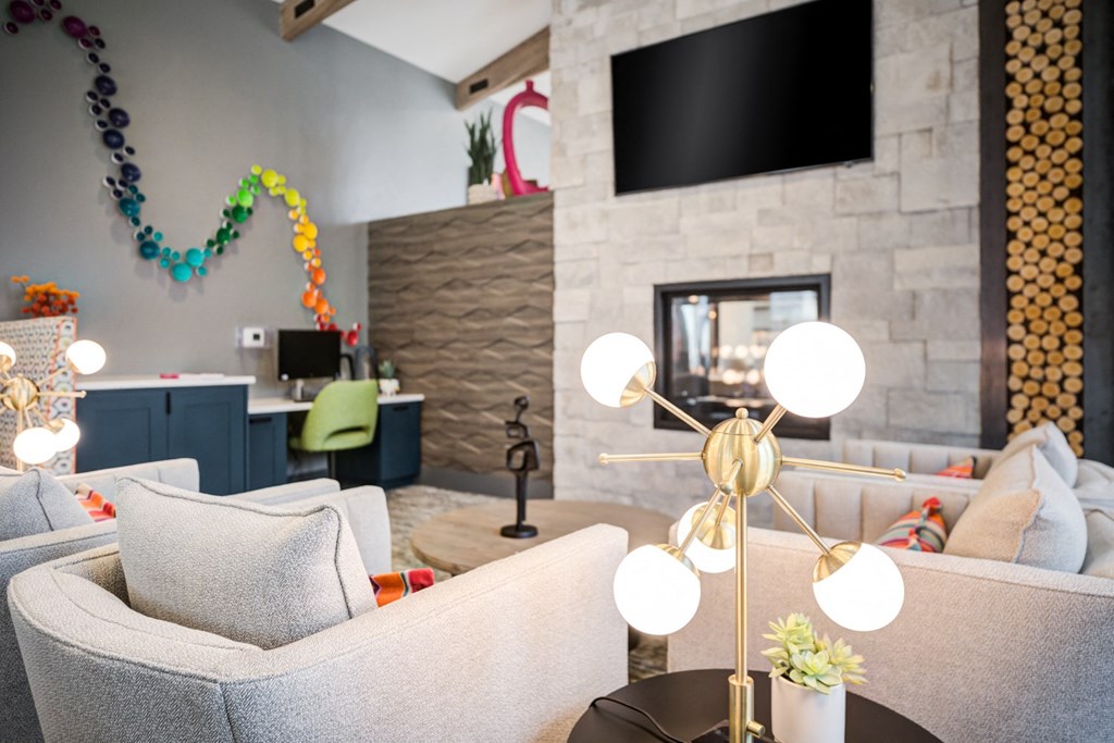 a living room with couches and chairs and a tv