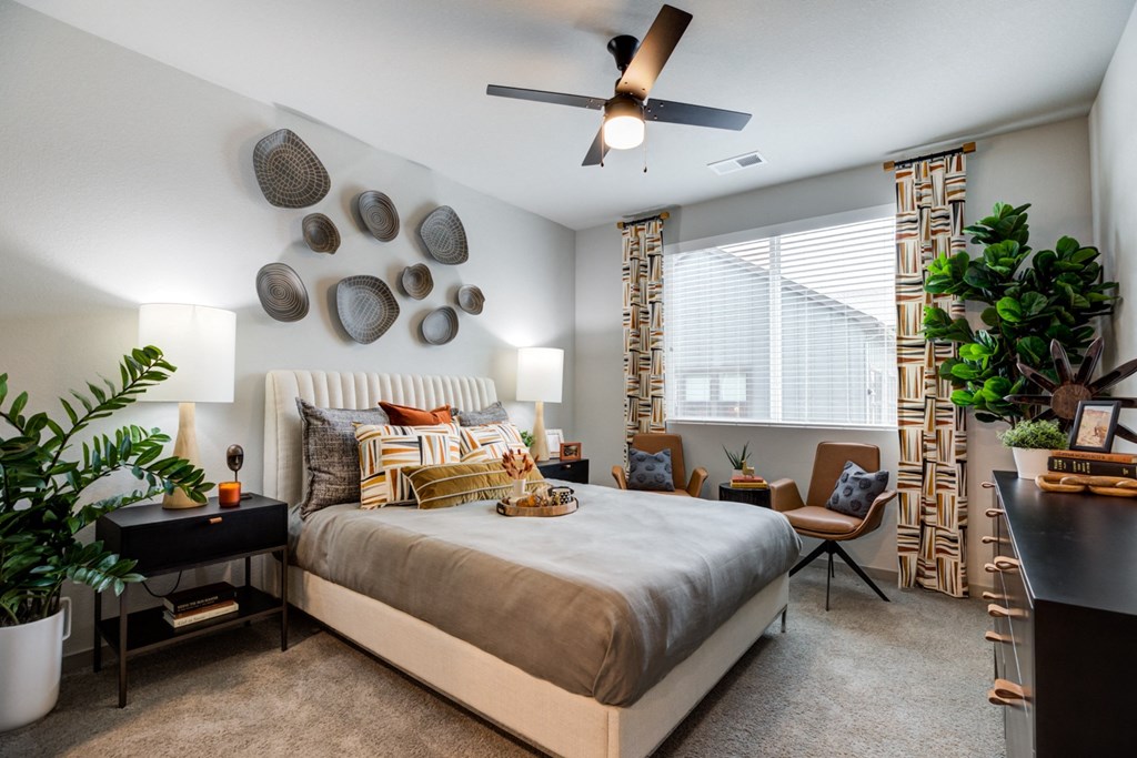 a bedroom with a bed and a ceiling fan