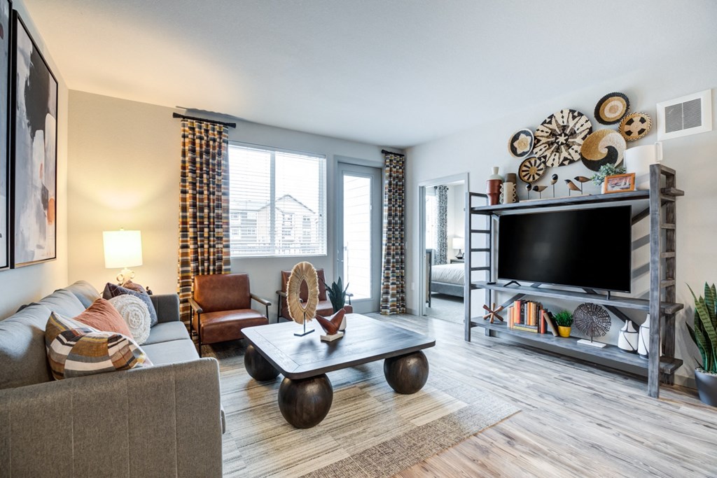 a living room with a couch and a coffee table and a television