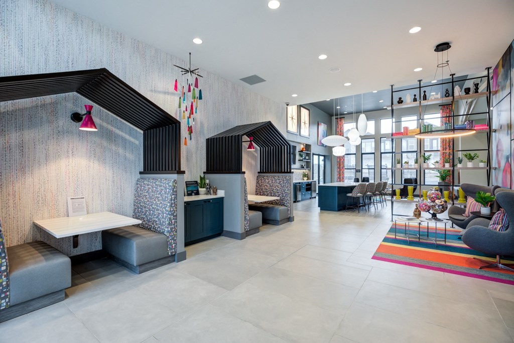 the lobby of a social club with couches and tables