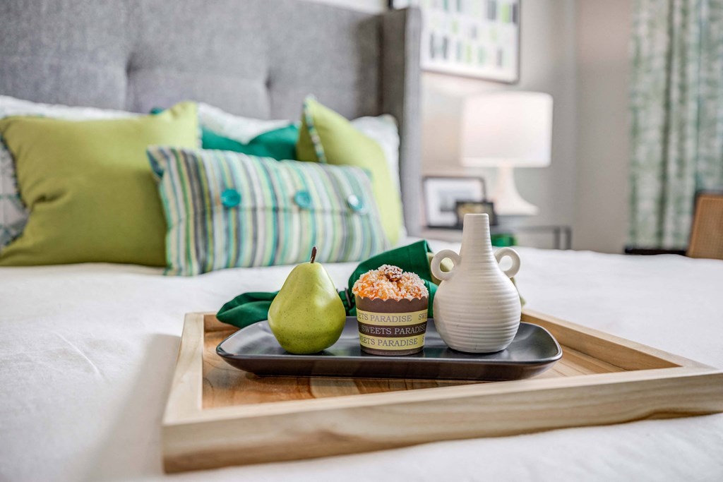 A wooden tray sitting on the bed
