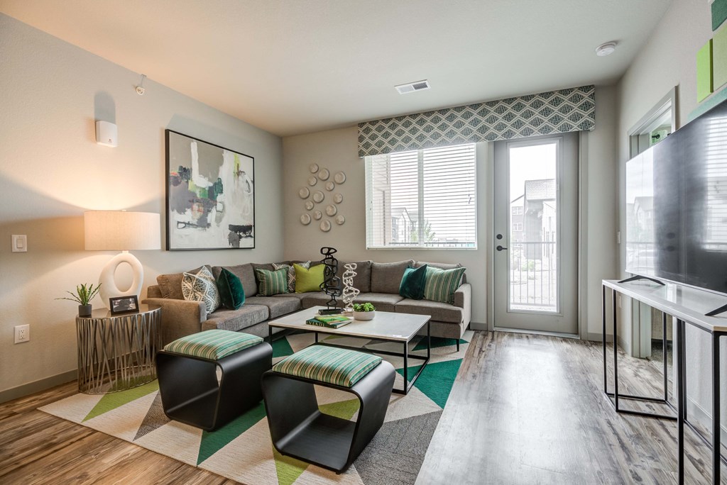 Living room with a balcony and hardwood flooring