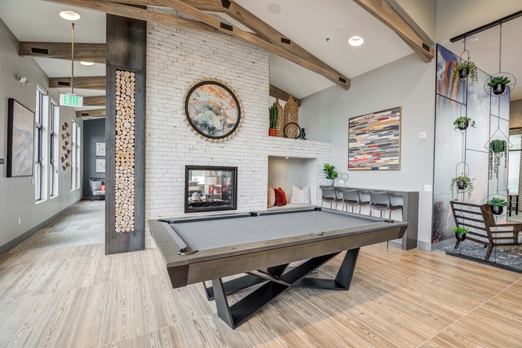 Game room with pool table and fireplace