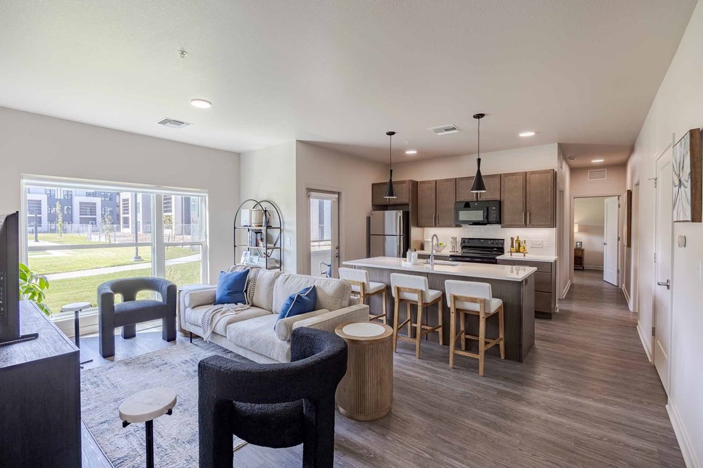 A modern kitchen with a bar stool and a dining table.