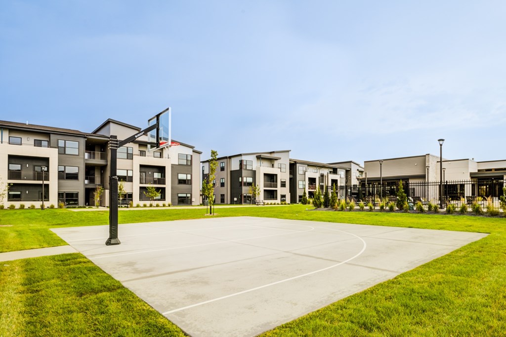 A large building complex with a flag flying in front of it.