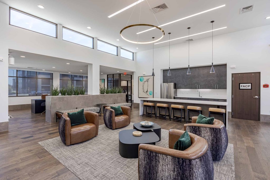 A modern office space with brown leather chairs and a wooden coffee table.