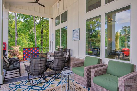 A patio with chairs and a table.