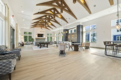 A spacious living room with wooden floors and furniture.