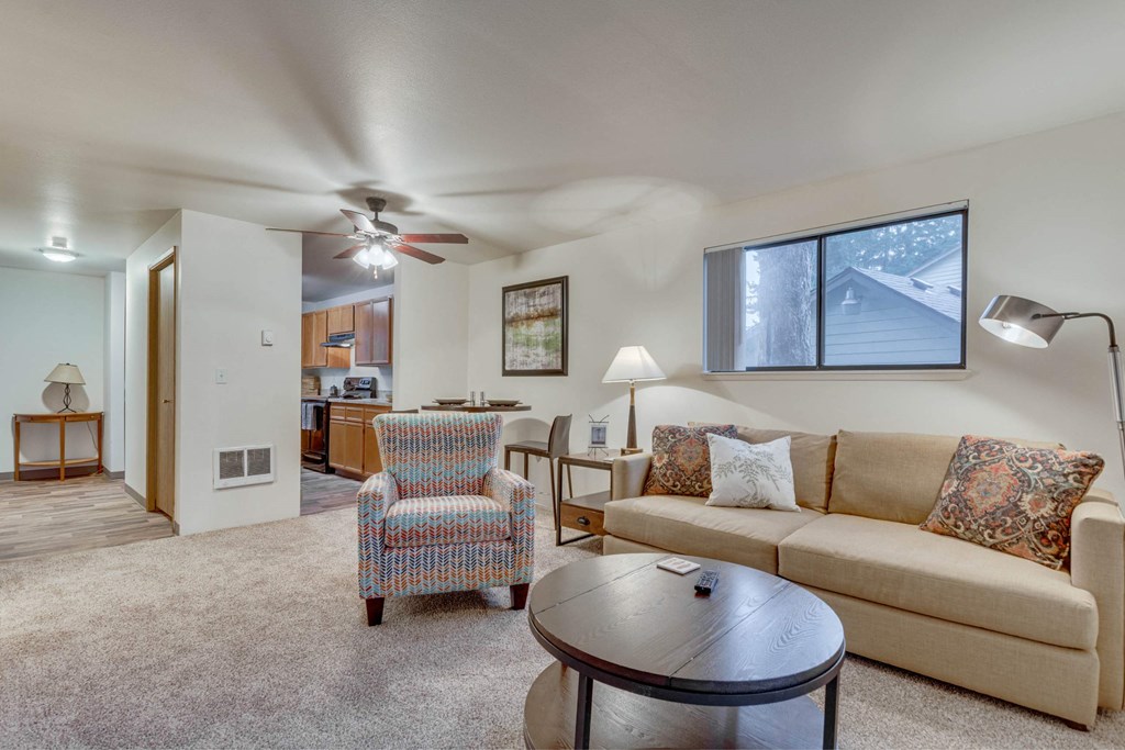 A living room with a couch, chair, and coffee table at Aspenridge Apartments, Washington